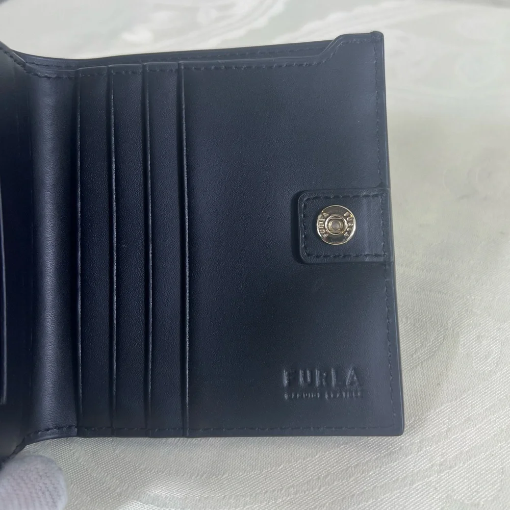 1017: Furla Black Pebbled Leather Compact Bifold Wallet